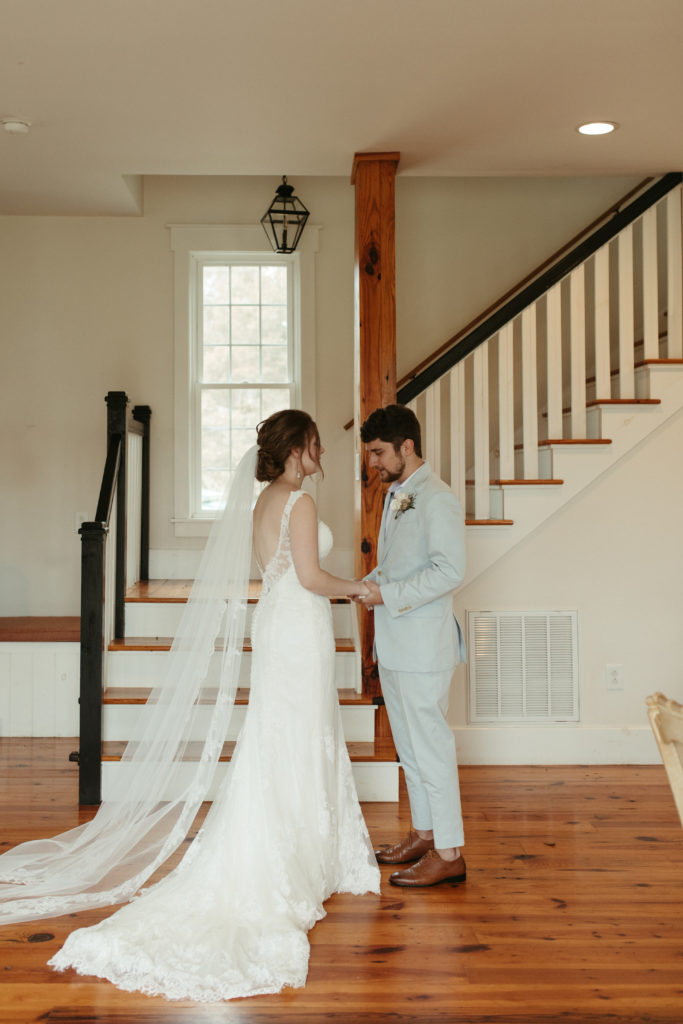 bride and groom first look in front of a staircase