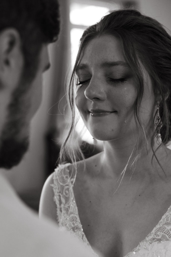 tear rolling down bride's cheek during first look